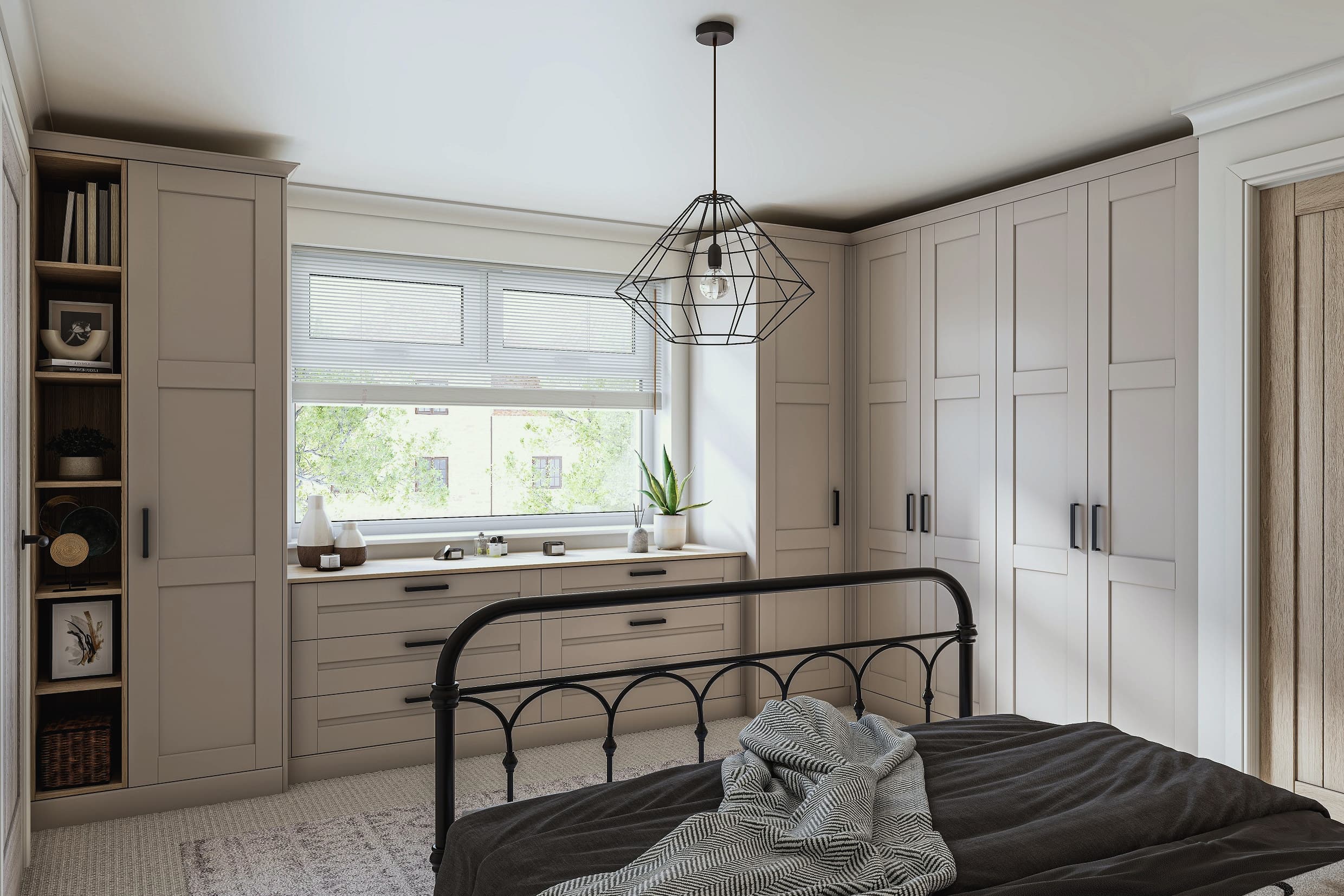A fitted bedroom with matt denim-blue shaker wardrobes and black knobs, on a warm oak floor